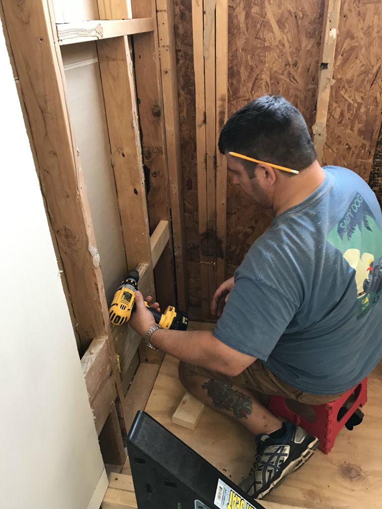 Adding supports for the shower seat (that black thing on the floor in the foreground)