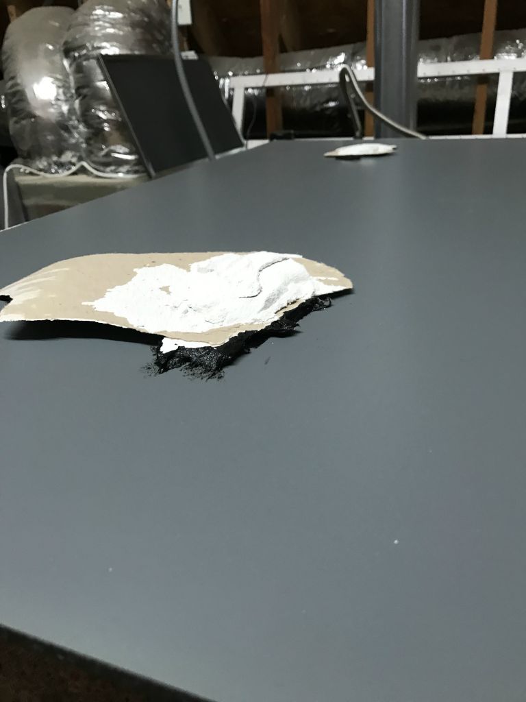 It is thick stuff!  Plastic scraper and a hairdryer are my tools.
