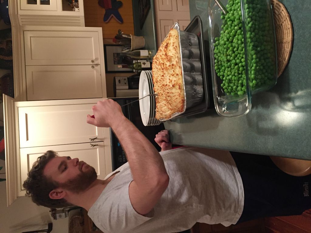 Tyler cuts into the fish pie - our traditional Christmas Eve meal