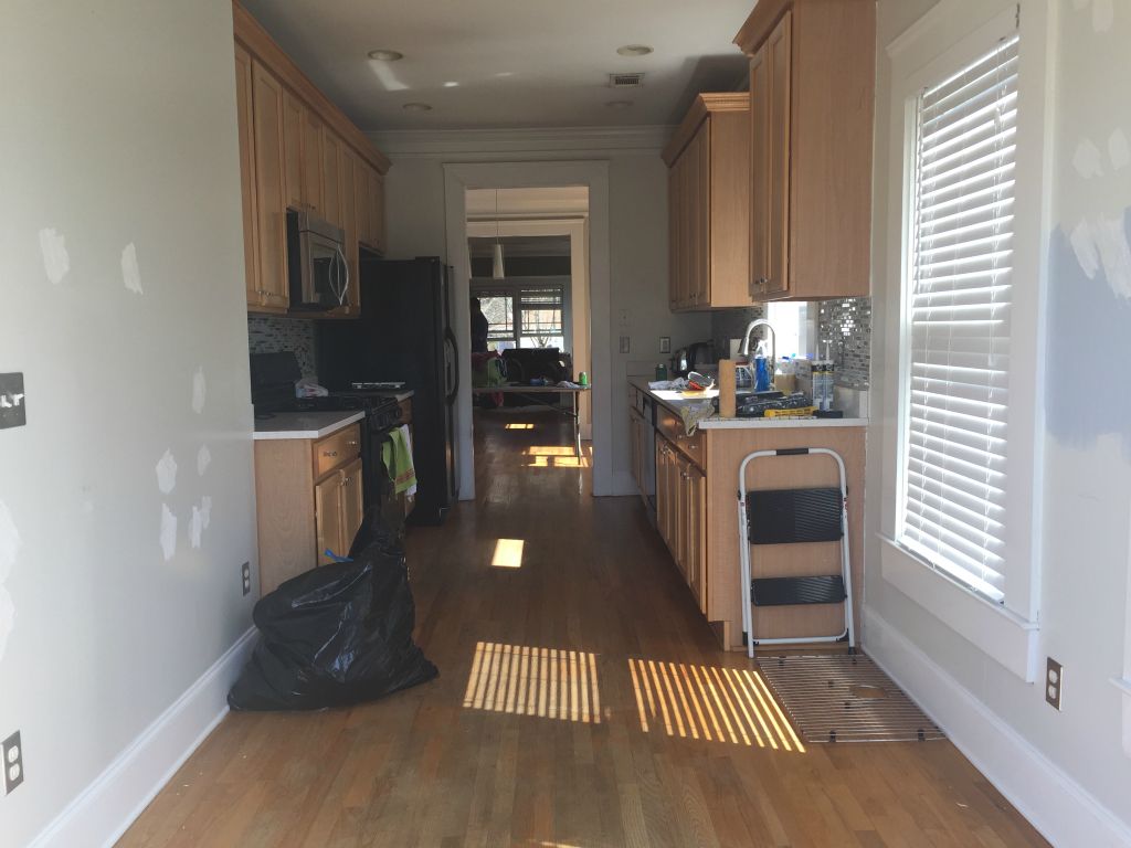 Looking into the kitchen from the back door.  We are going to get the floors refinished.  They are in bad shape in here.