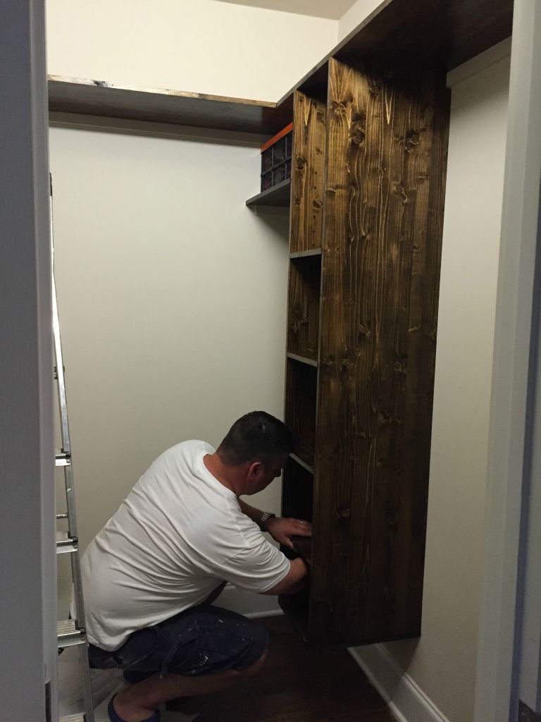 Nick installing the shelving