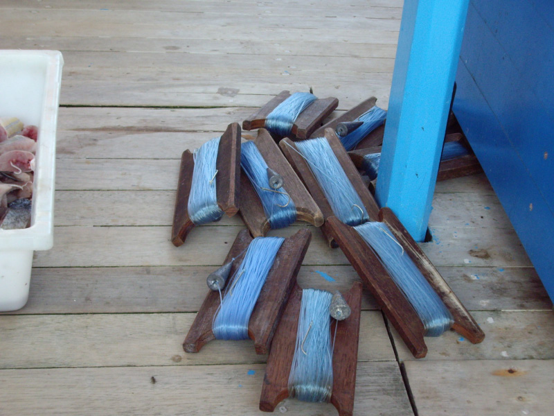 fishing line on boat with part of bait box