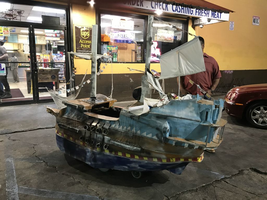 On our way to the comedy club we admire a pirate ship wheelchair at a convenience store.